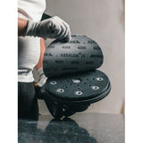 Person attaching a Mirka 9" Abralon J3 polishing abrasive disc on a LEROS sander