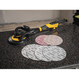 A Mirka LEROS-S short 9" sander with an assortment of 9" Abranet and Abralon sanding discs spread out on a countertop