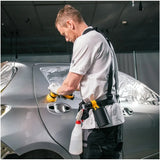Person wearing a Mirka 8991199111 work belt while working on a car with tools, performing a detailing and repair task.
