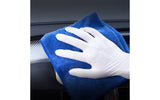 Dyna Grip Latex White glove holding a blue microfiber cloth against a car interior background