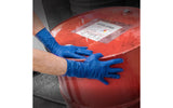 Person wearing Thickster blue gloves touching a red barrel with a label on it.