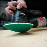 Image of RUPES PROCUT 4" x 6" x 6" Delta 10-Hole Film Abrasive Vacuum Sanding Sheet attached to a RUPES iBrid HSS73 sander, sanding a wood surface.