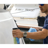 Person cleaning a yacht with RUPES XP-900 Polymer Sealant and a microfiber cloth